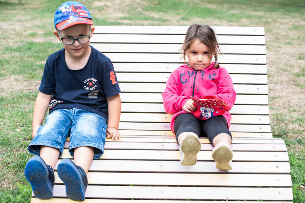 St. Suitbert: Junge und Mädchen sitzen auf einer Bank